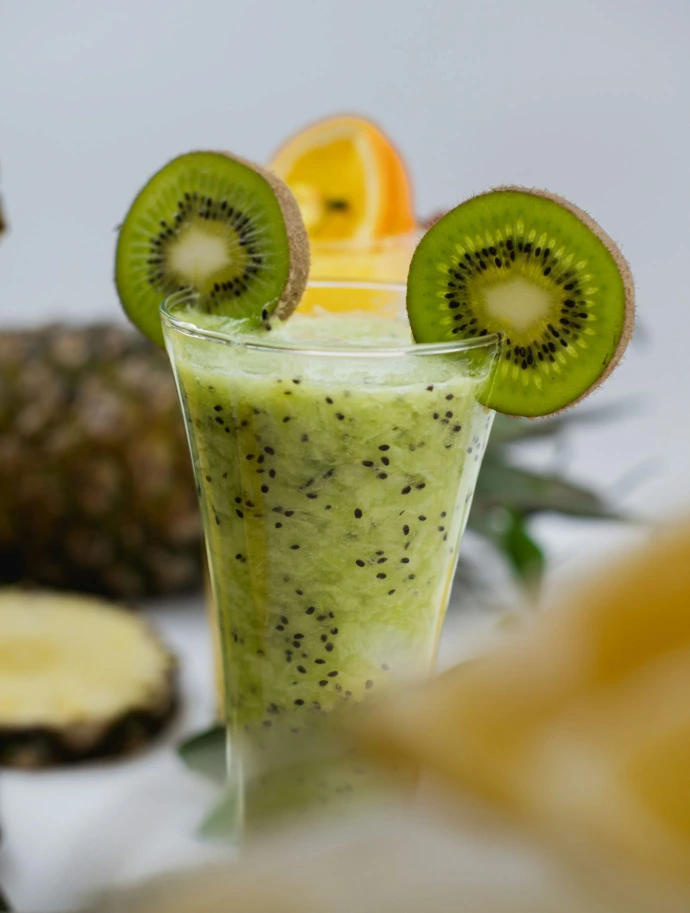 a smoothie with kiwi slices on top of it